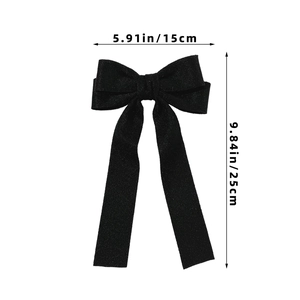 Detail view of a black bow hair clip with long ribbons, size 5.91in width and 9.84in length