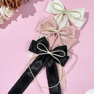 Elegant ballet style satin bow hair clips set in black, pink, and beige with ruffle edges