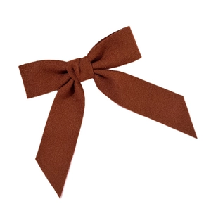 Caramel wool bow hair clip with matte texture and soft retro aesthetic for women