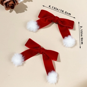 Detailed view of red velvet bow hair clips with white pom poms and size measurements