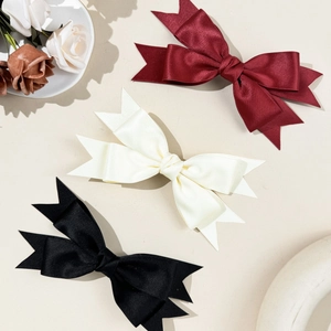 Elegant satin bow hair clips in wine red, cream, and black colors for women