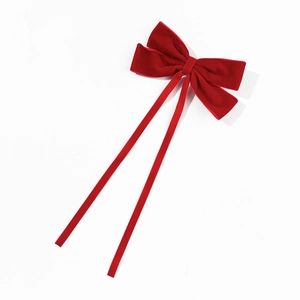 Elegant red velvet bow hair clip with long ribbons in a classic minimalist style