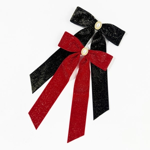 Elegant red and black velvet bow hair clips with pearls and shimmering gold silk details
