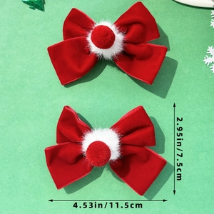 Detail view of red velvet bow hair clips with white pom poms and 4.53 inch size markings