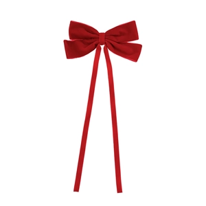 Elegant red velvet bow hair clip with long ribbons for women in minimalist style
