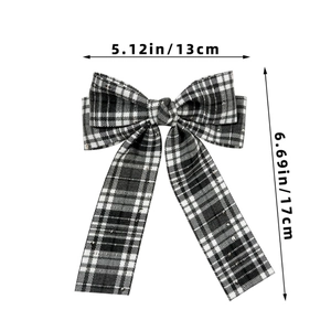 Detail view of a black and white plaid bow hair clip with sequins and size dimensions