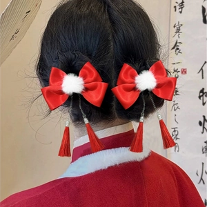 Chinese style red bow hair clips with white pom poms and tassels for festive hairstyles