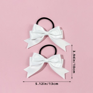 Close-up of white silk satin bow hair ties showing precise 13cm width and 10cm height details