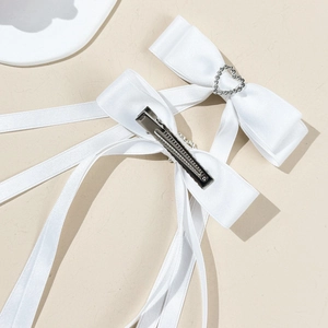 White satin bow hair clips with heart rhinestones and long ribbons for elegant styling