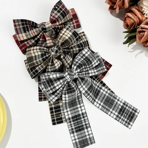 Vintage plaid bow hair clip set with long ribbons in classic red and brown check patterns