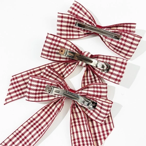 Detailed view of British style burgundy plaid bow hair clips with silver metal clip base