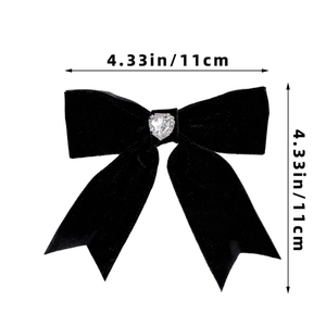 Detail of black velvet bow hair clip with heart rhinestone and 4.33 inch size dimension