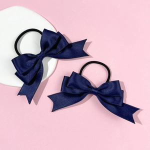 Set of two sweet navy blue bow hair ties with elastic bands on pink background