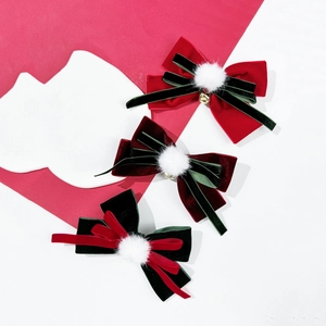 Christmas velvet bow hair clips set with pompons and bells on a red and white background
