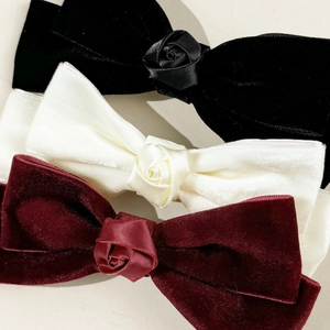 Three-piece velvet bow hair clip set with rose accents in black, cream, and wine red colors