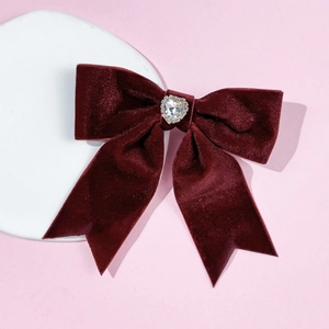Detailed macro view of the velvet heart hair clip with shiny rhinestone centerpiece