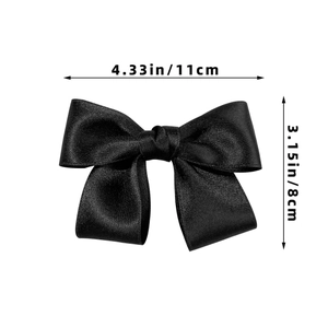 Detailed size view of a black satin bow hair clip measuring 4.33 inches by 3.15 inches