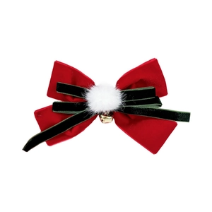 Velvet Christmas bow hair clip with red and green layers, pompom, and gold bell accent