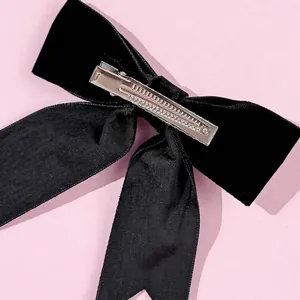 Elegant black velvet bow hair clip with rhinestones and long ribbons for women