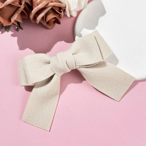 Elegant off-white woolen bow hair clip for women featuring a textured minimalist design