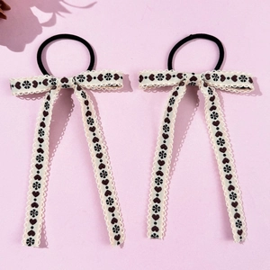 Close-up of heart embroidered ribbons with lace trim on sweet ballet style hair ties