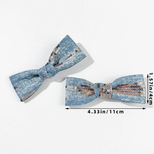 Detail view of denim sequin bow hair clips in light blue with 11cm length measurement