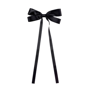 Elegant large black satin bow hair clip with long flowing ribbons on white background