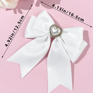 Detailed view of white satin bow with heart pearl center and precise size measurements