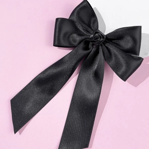 Vue détaillée du nœud en satin noir élégant avec une petite rose centrale