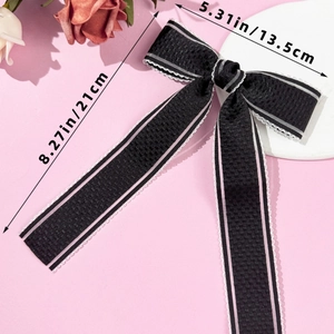 Detailed size view of black lace bow hair clip with ribbons measuring 21cm by 13.5cm