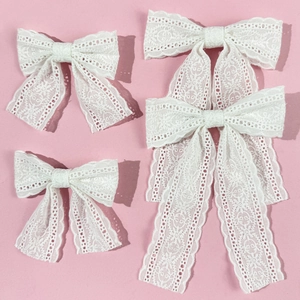 Elegant 4-piece set of white lace bow hair clips with delicate hollow floral patterns