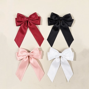Elegant four-piece satin bow hair clips in burgundy, black, pink, and white colors