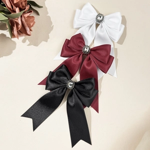 Three-piece set of satin bow hair clips with rhinestones in black, white, and wine red