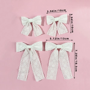 Detailed view of white lace bow hair clips with specific dimensions on pink background