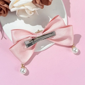 Elegant pink satin bow hair clip with white pearl pendants and metal crocodile clip