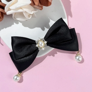 Elegant black satin bow hair clip with vintage pearls and rhinestone center detailing