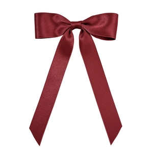 Elegante fermaglio per capelli con fiocco in raso rosso vino e nastri lunghi su sfondo bianco
