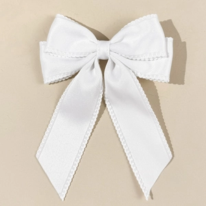 Detailed macro view of white satin bow hair clip with elegant scalloped lace edges