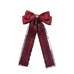 Elegant burgundy satin bow hair clip with black lace ribbons and a center crystal stone
