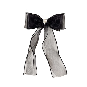 Elegant black tulle bow hair clip with faux pearl and rhinestone center on white background