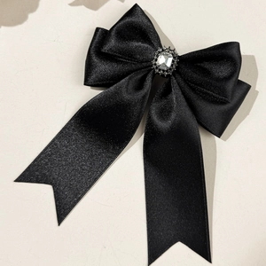 Elegant black satin bow hair clip with a sparkling rhinestone centerpiece for women