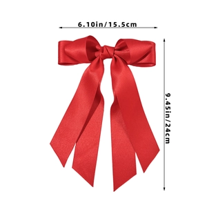 Macro view showing dimensions of a red satin bow hair clip with elegant long ribbon tails