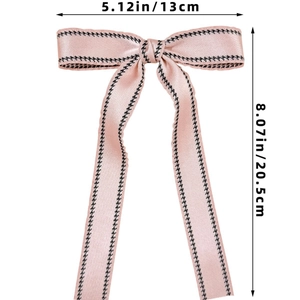 Pink houndstooth bow hair clip detail with dimensions 13cm wide and 20.5cm long