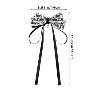 Detail view of black lace bow hair clip with pearl pendant showing dimensions 14x28 cm