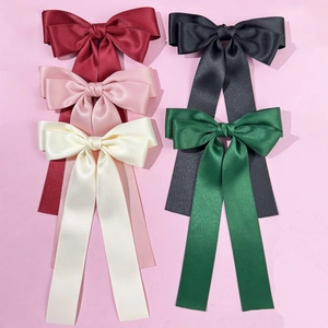 Elegant satin bow hair clips in five colors including burgundy, black, and forest green