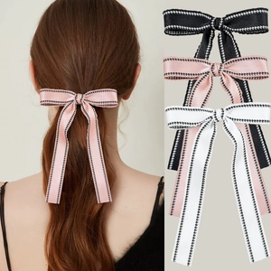 Elegant bow hair clip set with long ribbons in pink black and white houndstooth trim