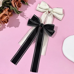 Paire de barrettes à nœuds élégants noir et crème avec rubans rayés pour femmes