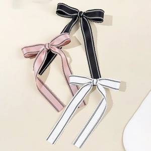 Three-piece set of elegant long ribbon bow hair clips in pink, black, and white colors