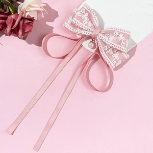 Elegant pink lace bow hair clip with pearls and long ribbons for romantic hairstyles