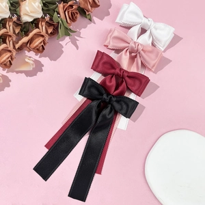 Elegant satin bow hair clips in white, pink, burgundy, and black with scalloped edges
